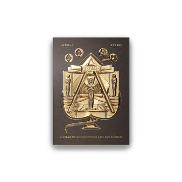 A deck of playing cards with gold foil detailing and an Oscar statuette design on the packaging.